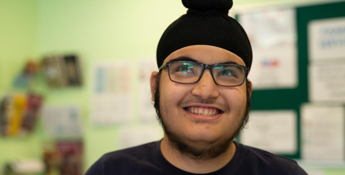 A boy in glasses smiling