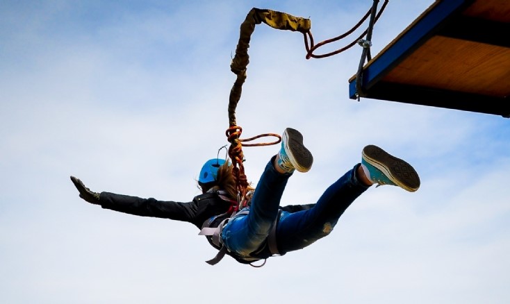 A person jumping off a platform during a bungee jump