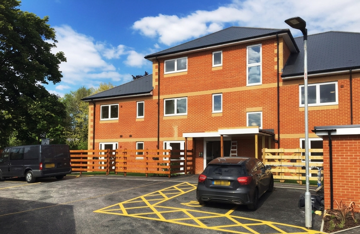 The outside of Aldershot Support Service - a bright, modern brick home with three floors.