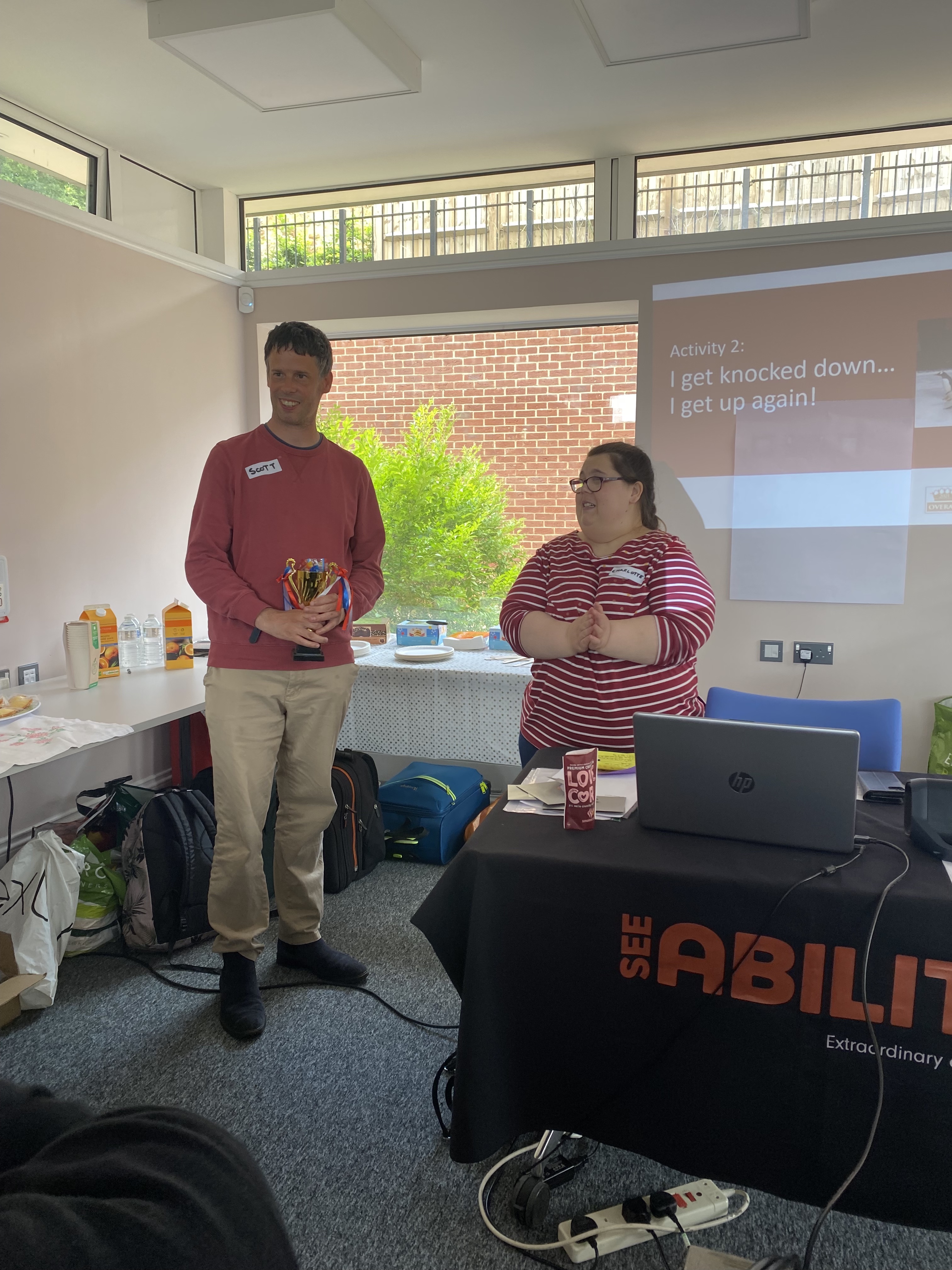 Charlotte presents Scott with an award