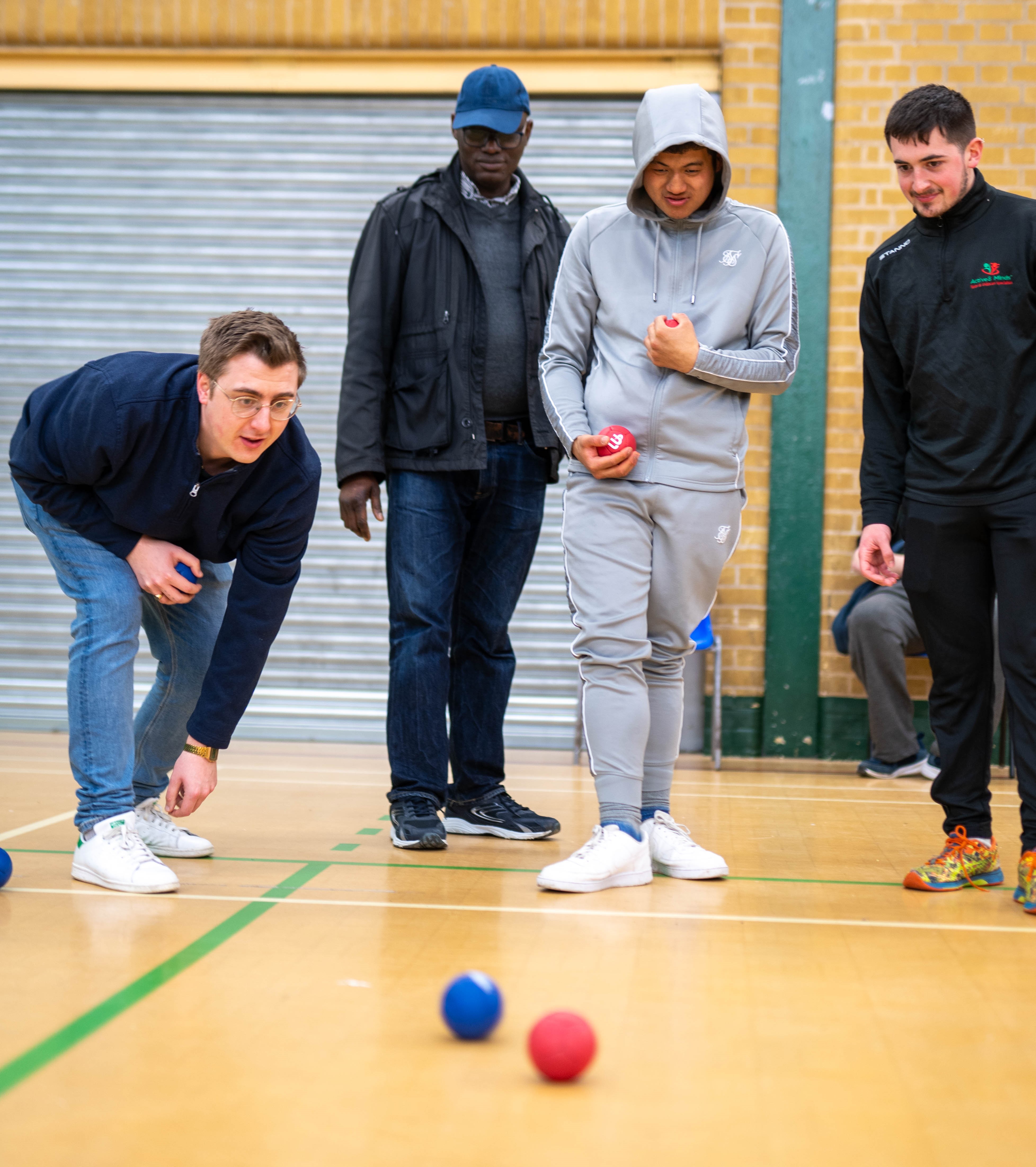Giban playing a bowling game with three other people
