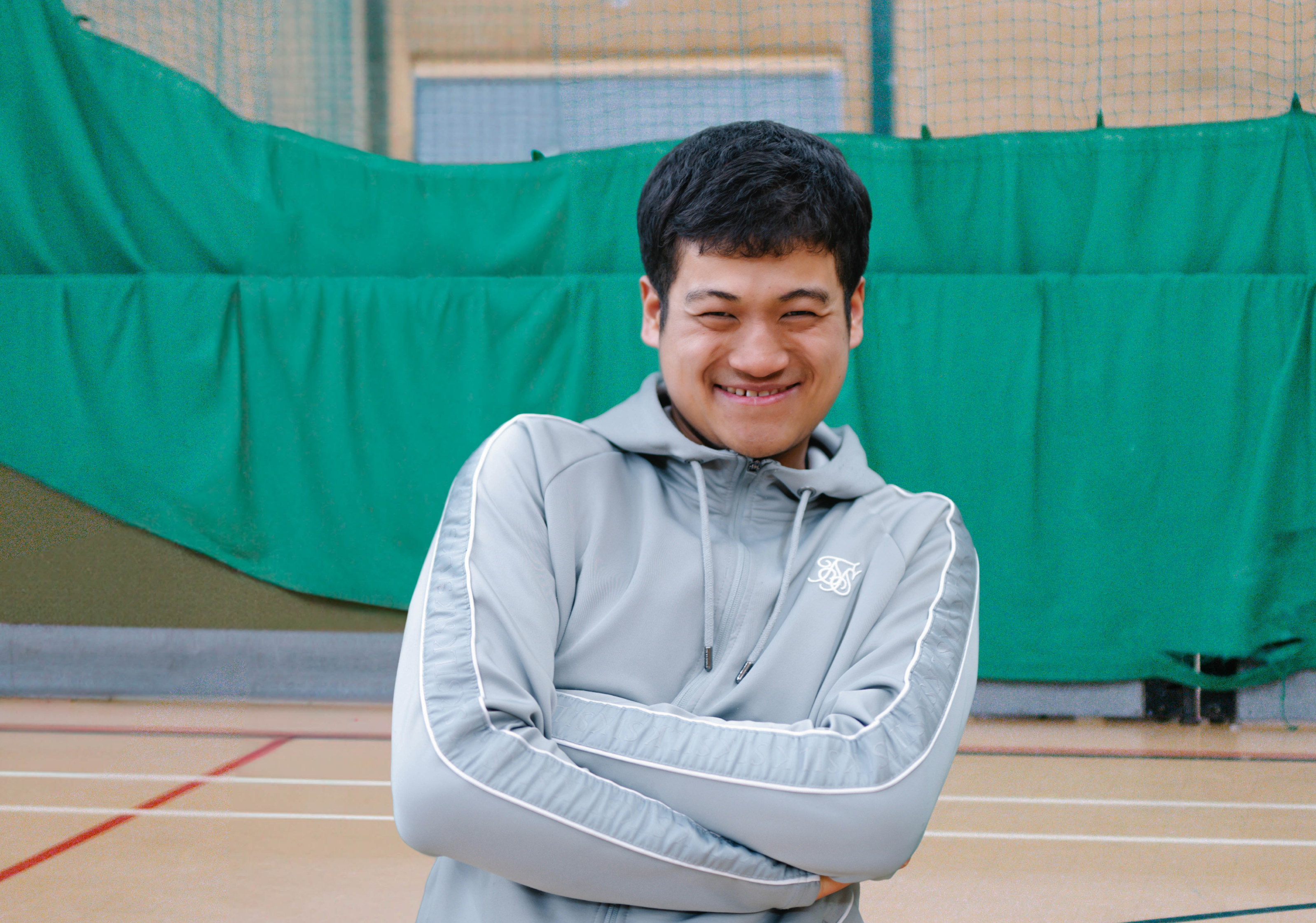 Giban smiling in a sports centre