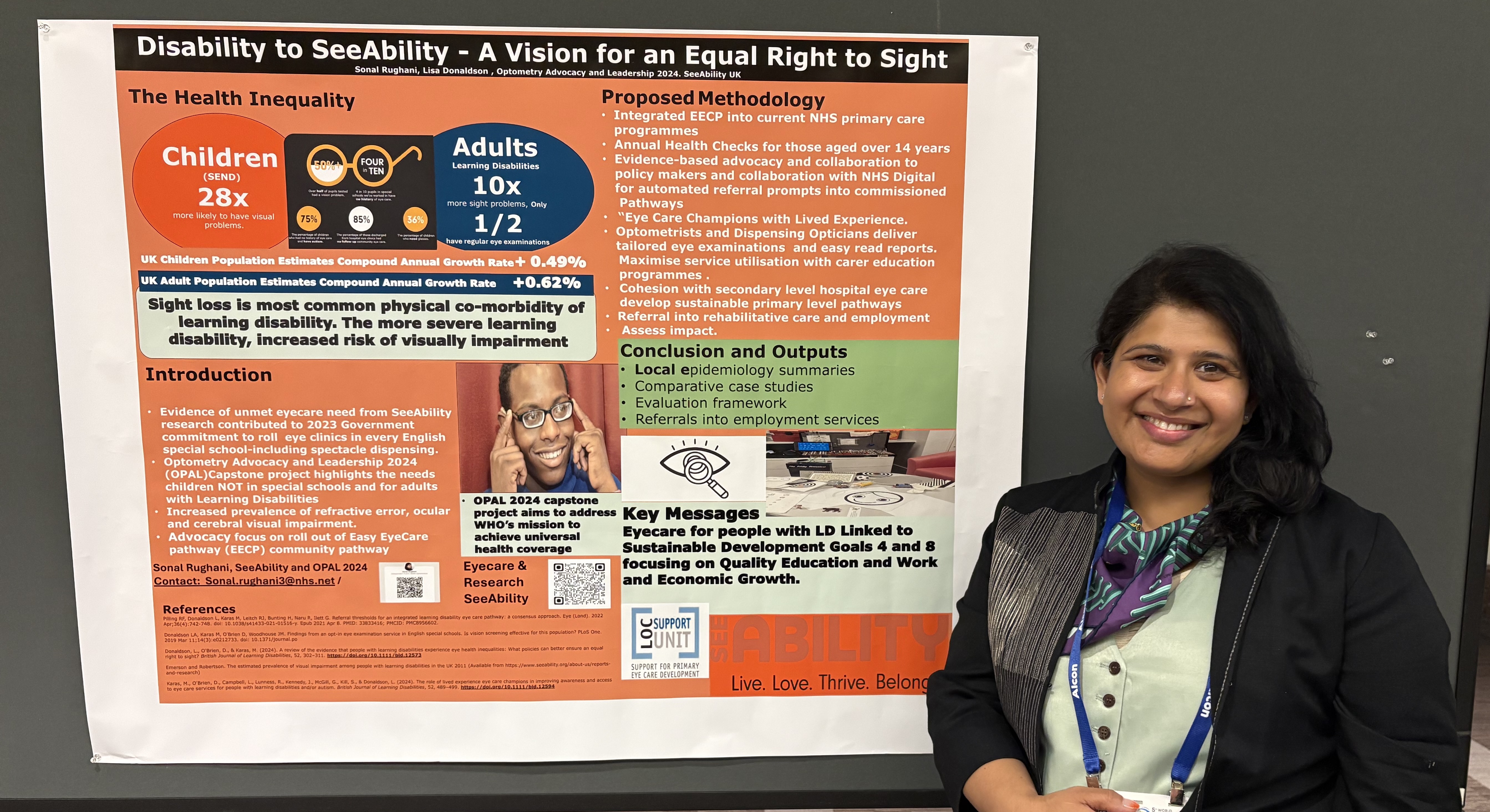 Sonal standing with the SeeAbility poster