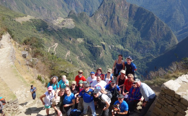 A group of people on the sunny inca trail mountains