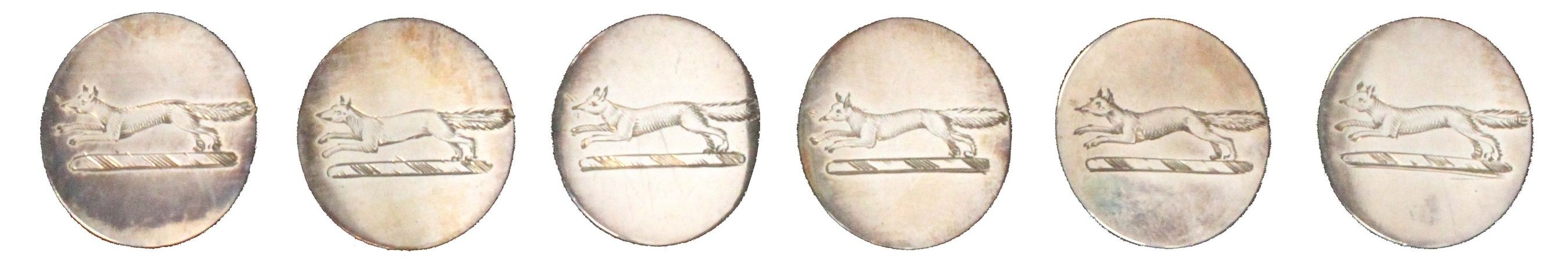 A set of six silver sporting buttons, each engraved with an image of a fox, dating from 1744 and 1746.