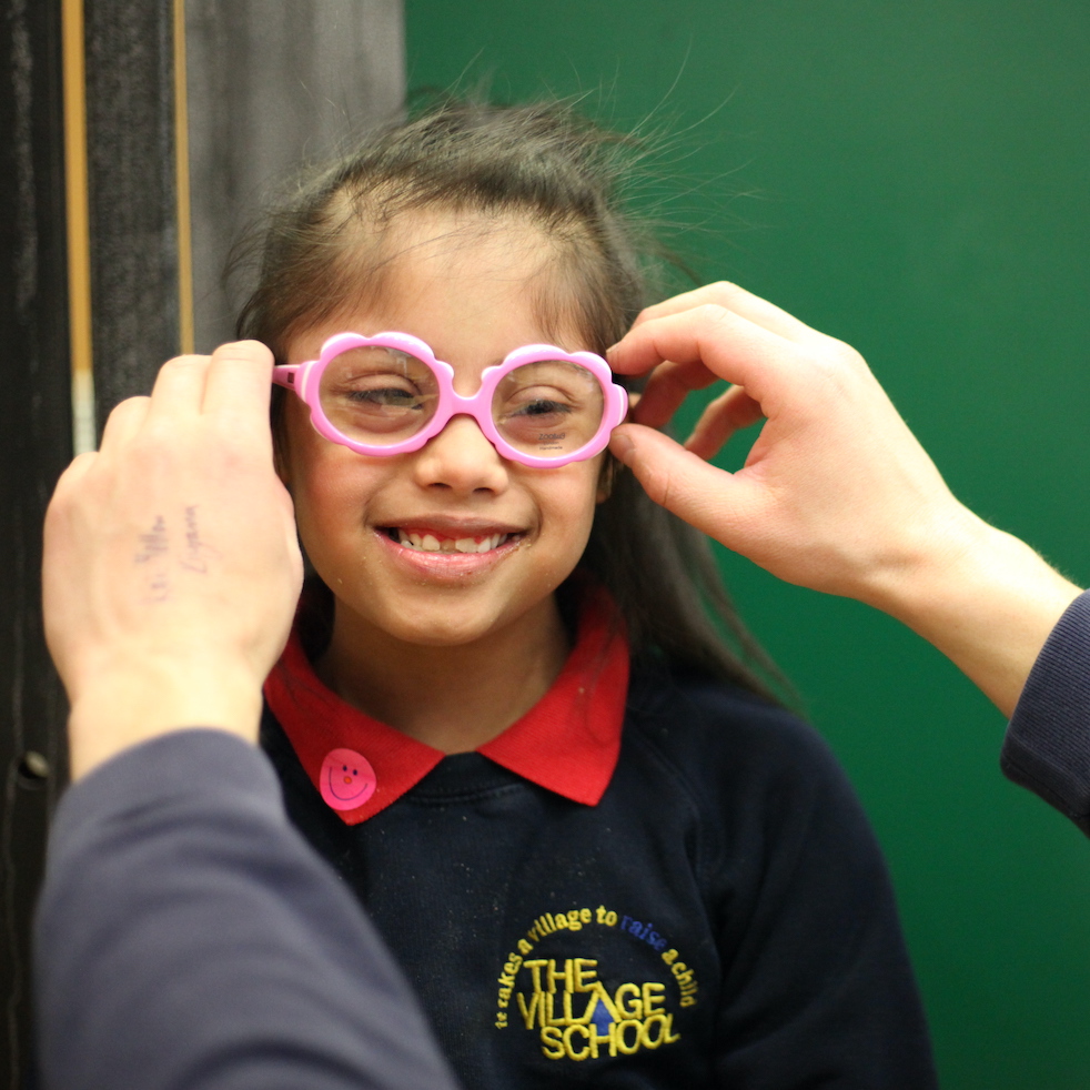 Kiyana smiles while having her glasses fitted