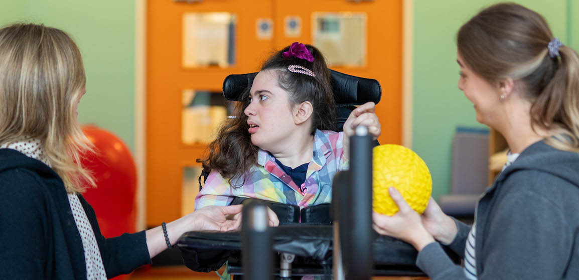 Lizzie with her physiotherapists