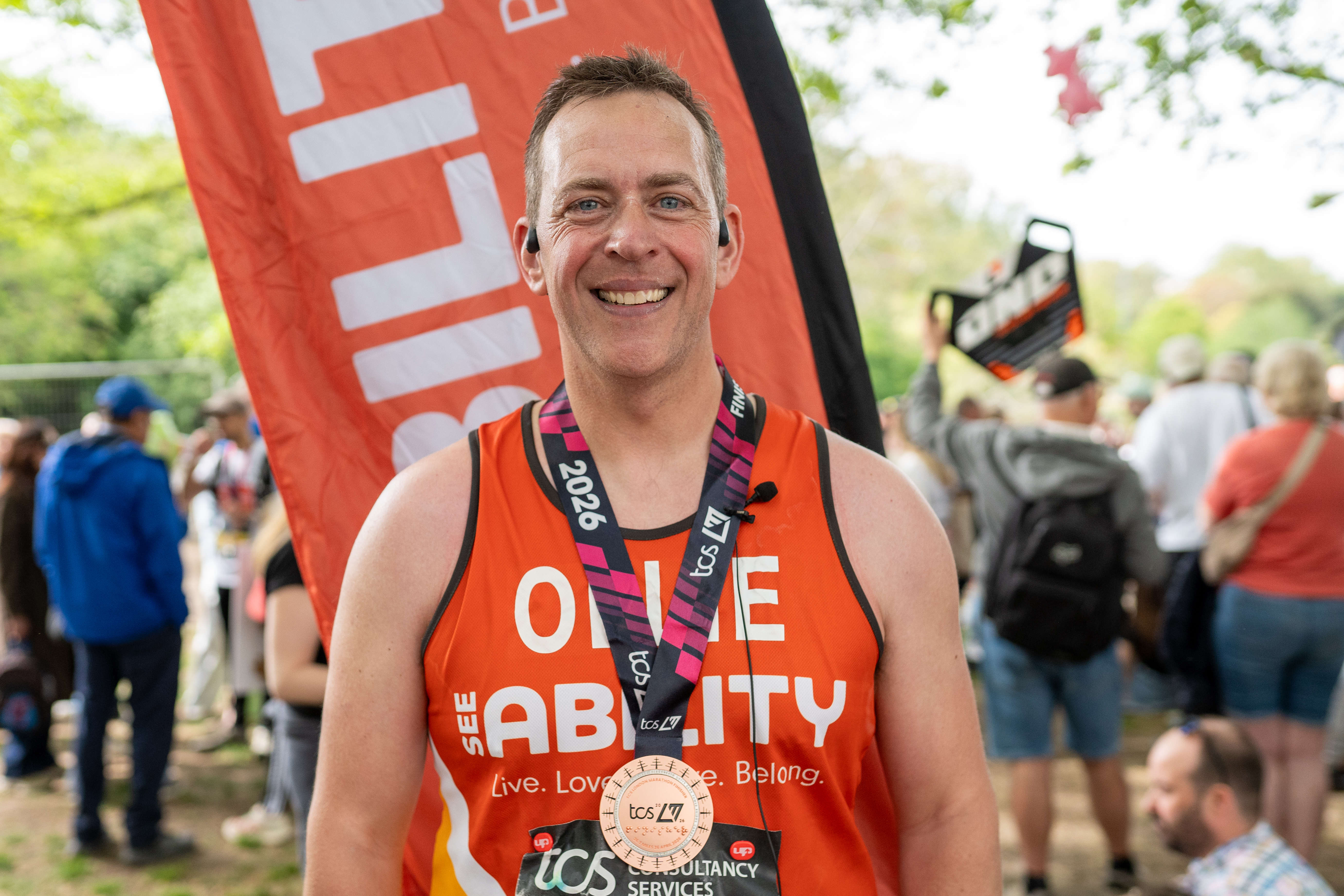 Ollie, one of our London Marathon runners, smiling with his medal