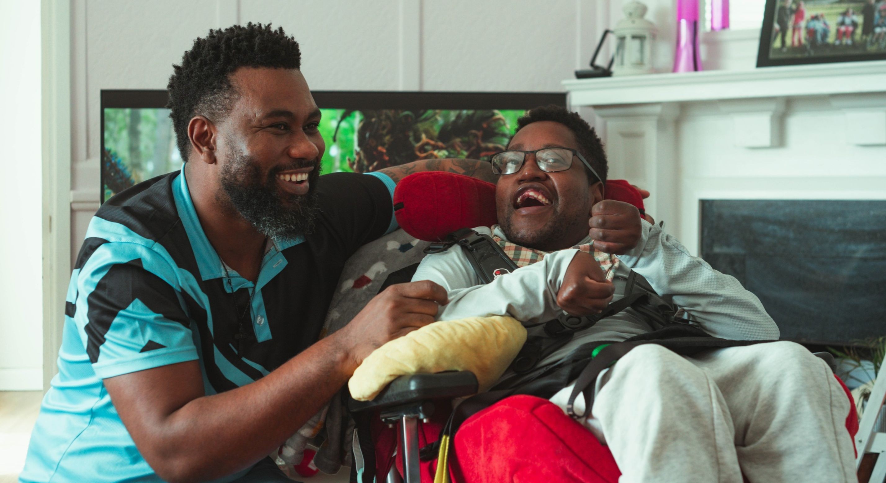 Saddick smiling with his support worker