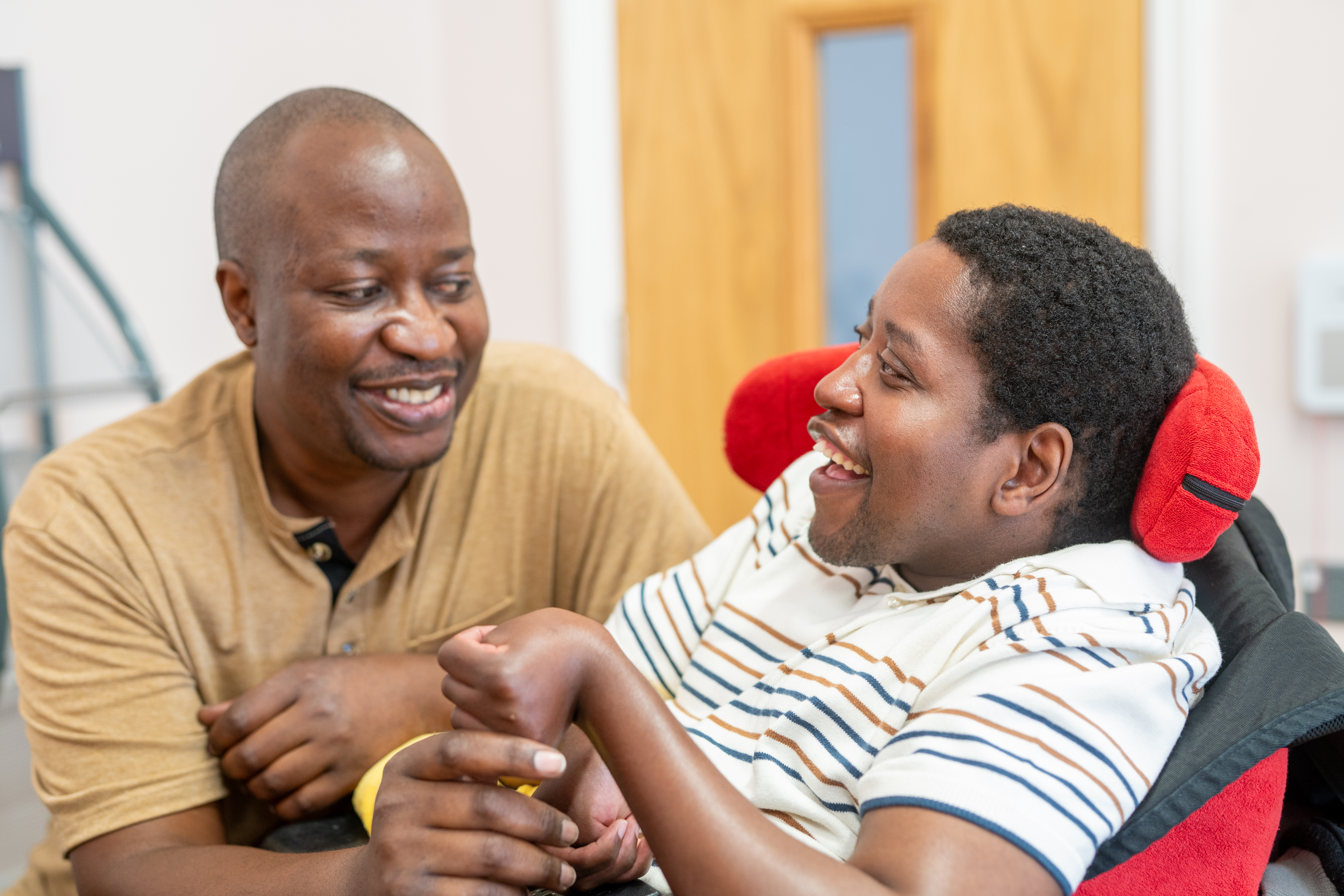 Sadick smiling with a Support Worker