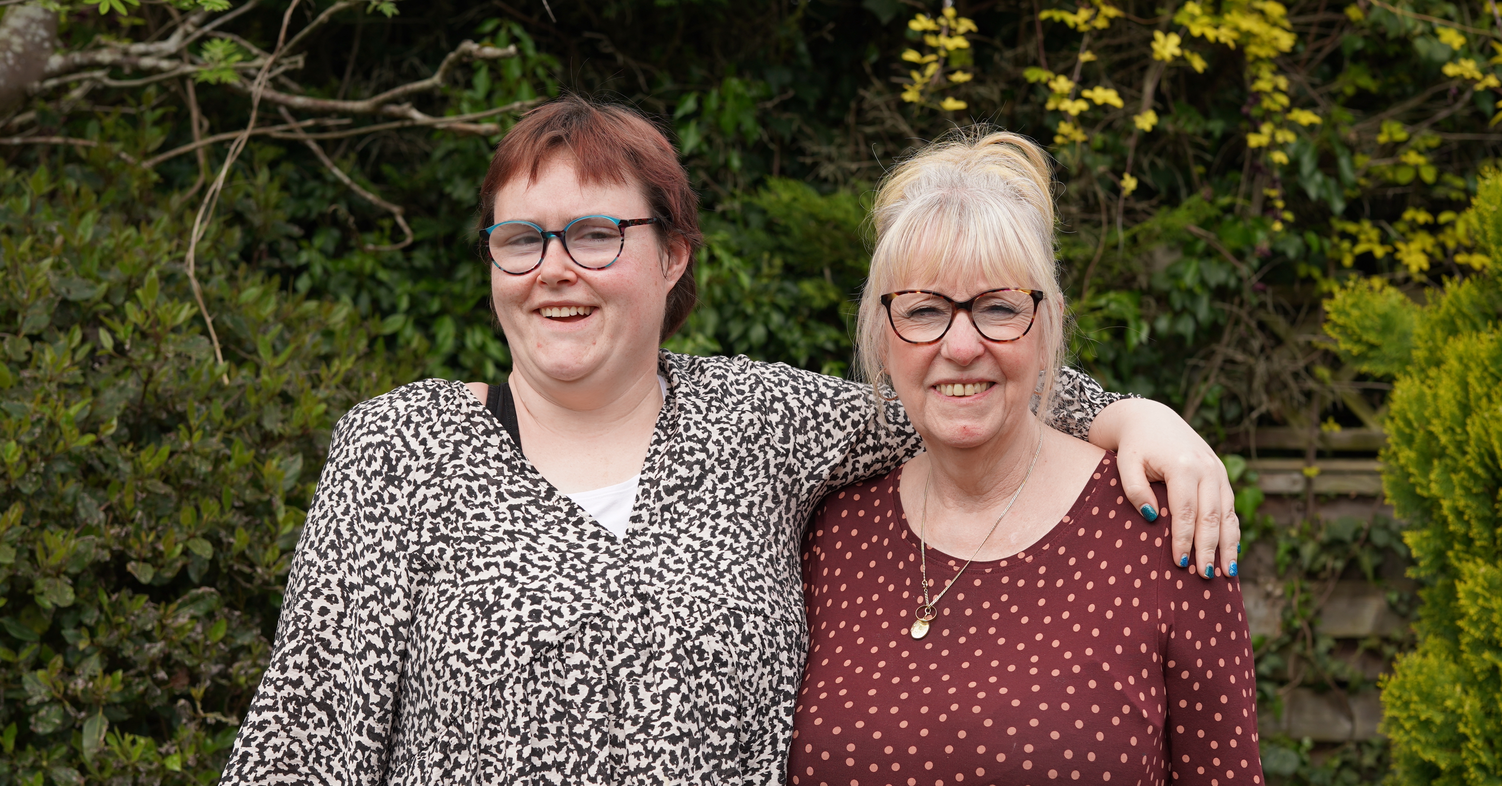 Grace and her support worker smiling