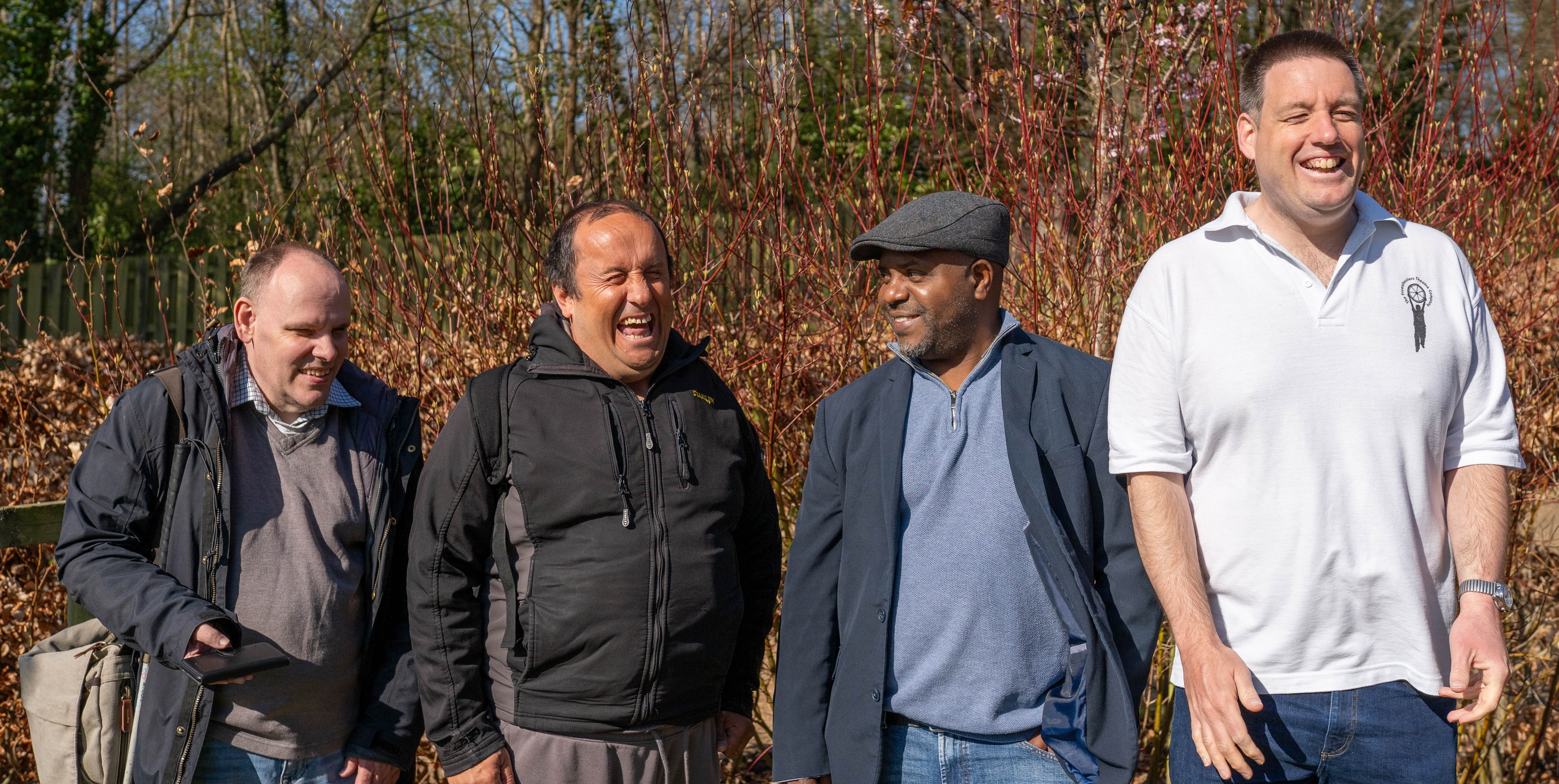 Luke, Stuart, Jan and Moses standing outside and smiling