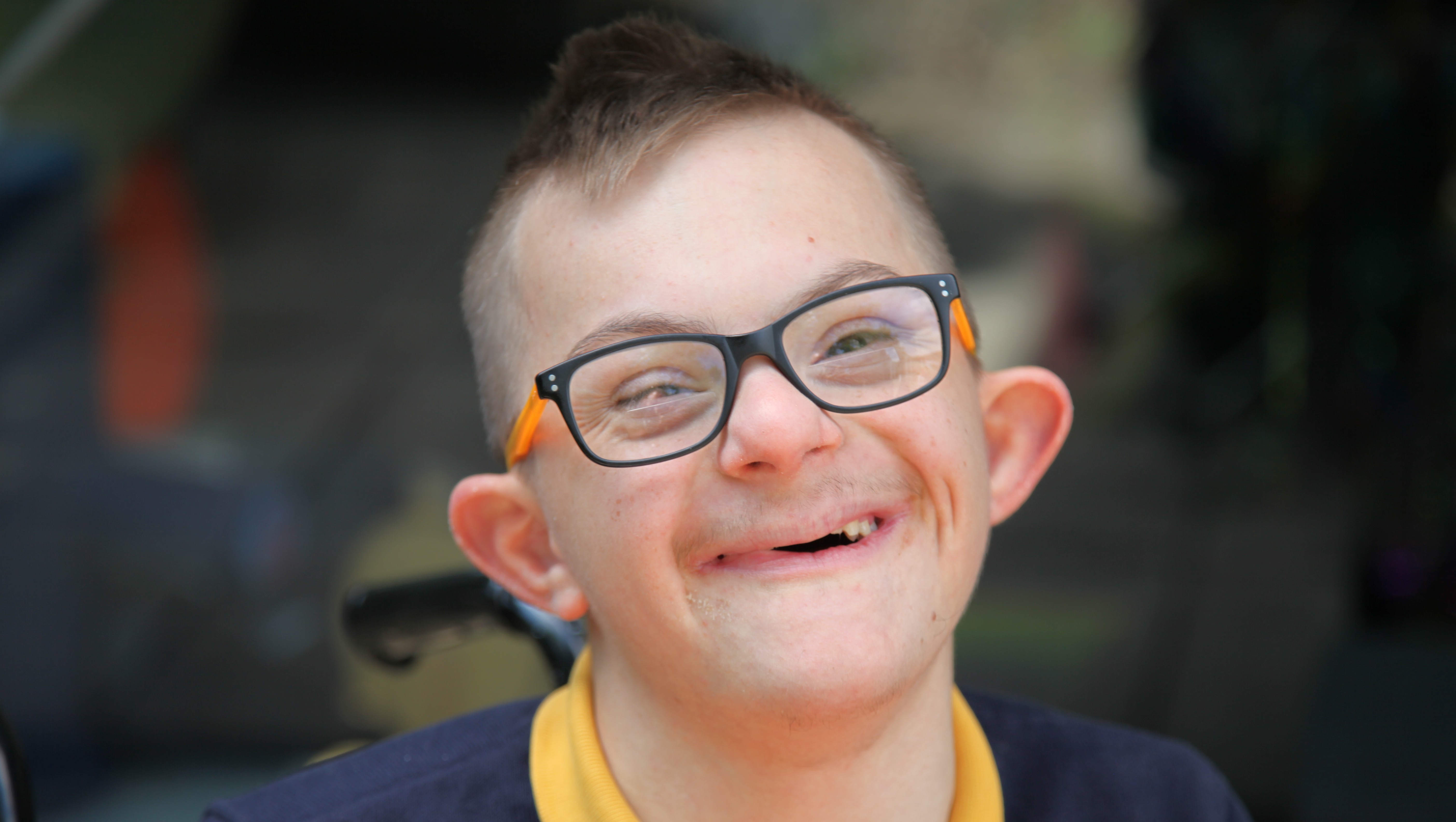 Alexandru smiling with his glasses