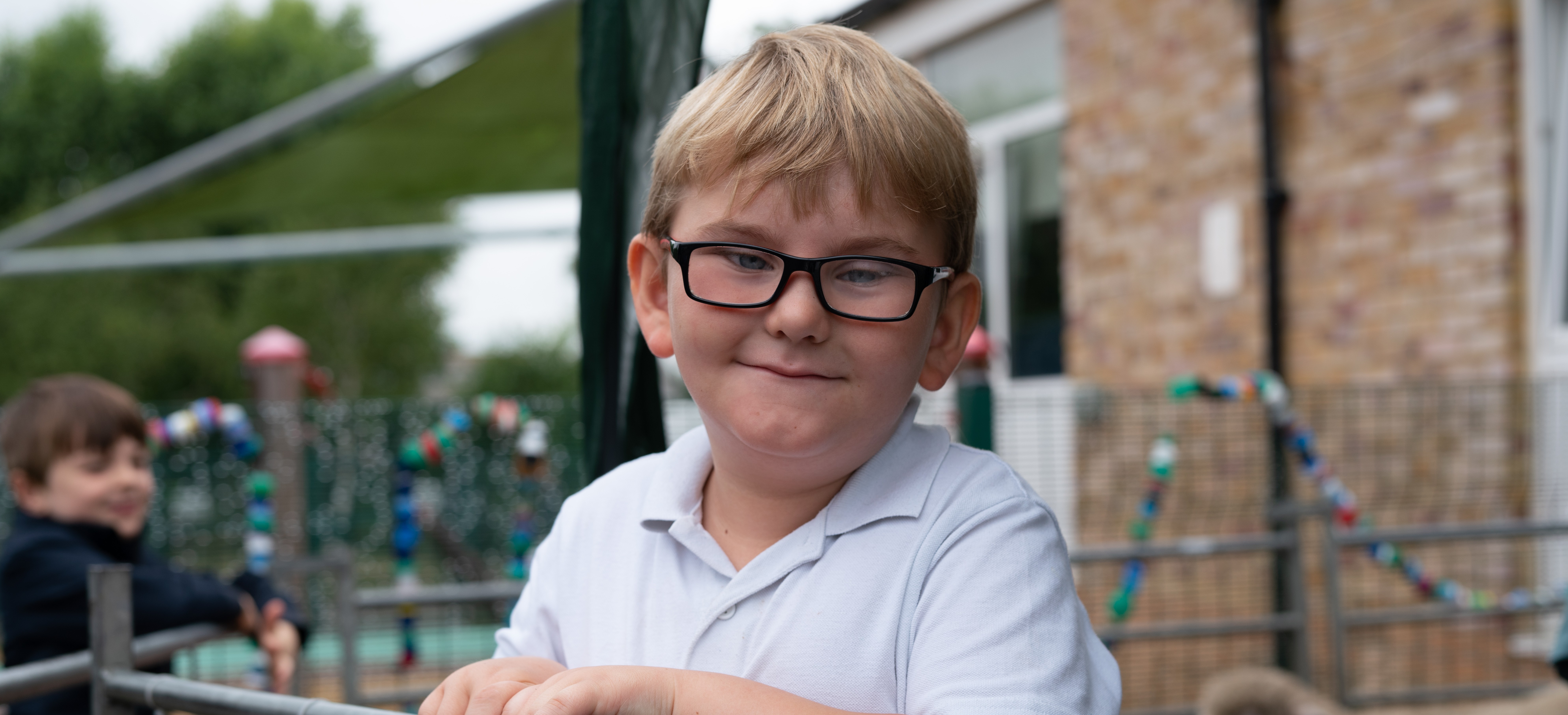 Nathan smiling at his school