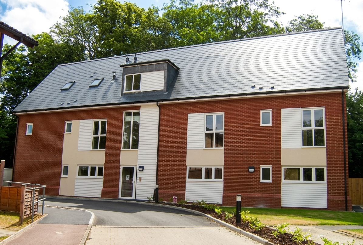 The outside of Surrey Views - a modern two-storey home with a pitched slate-style roof, complete with large windows and landscaped gardens.
