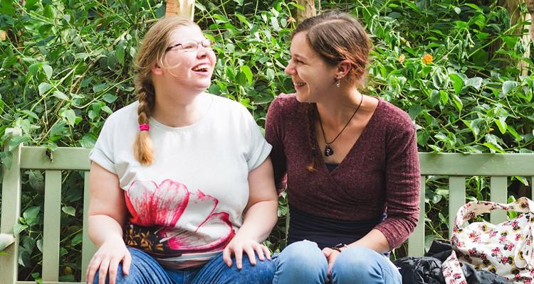 Two people sitting on a bench