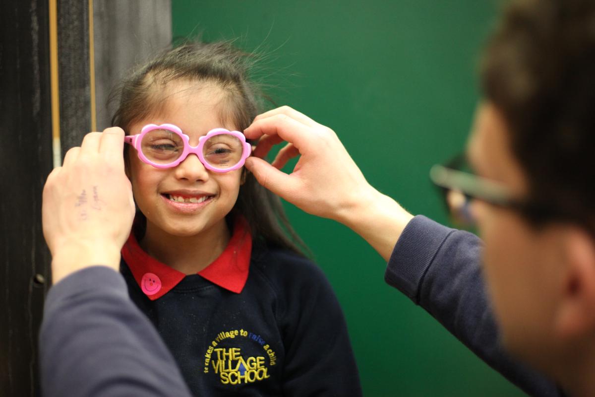 Kiyana smiles while having her glasses fitted