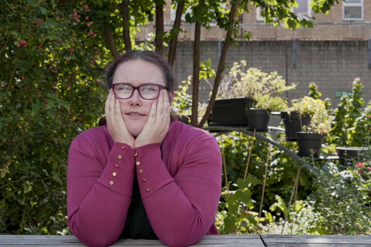 Grace leaning on a table