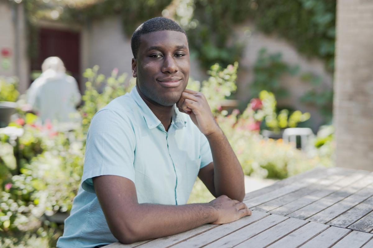 Lance leaning on a table