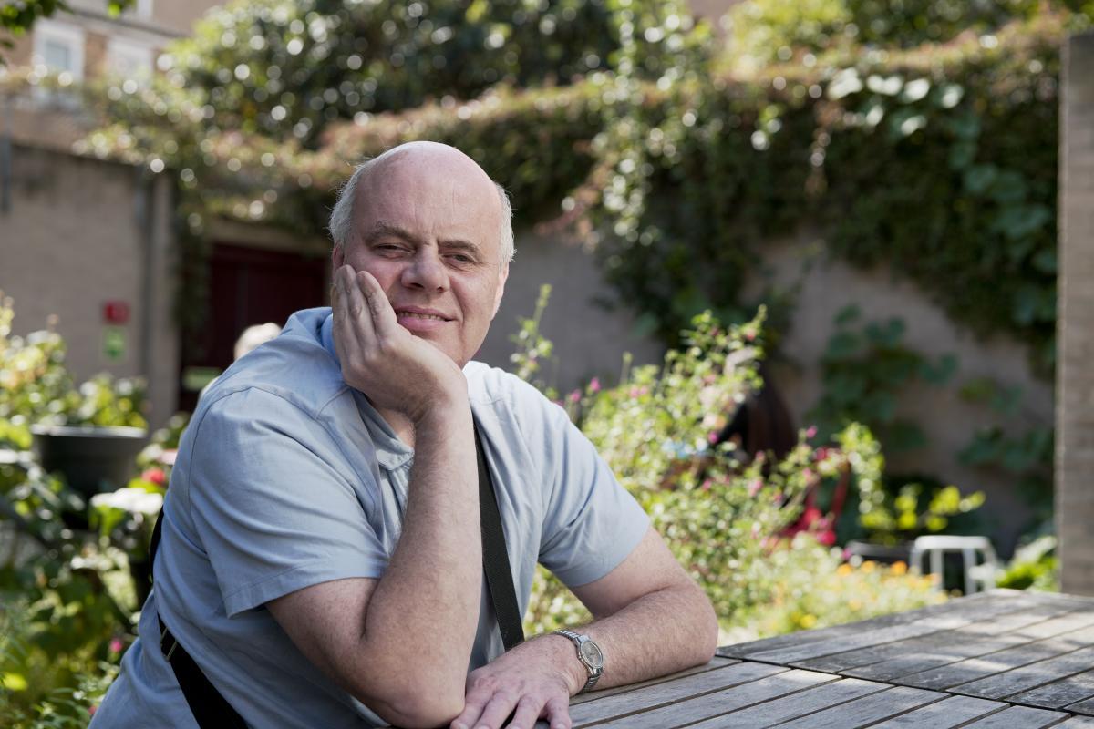 Wayne Chapman sitting outdoors smiling