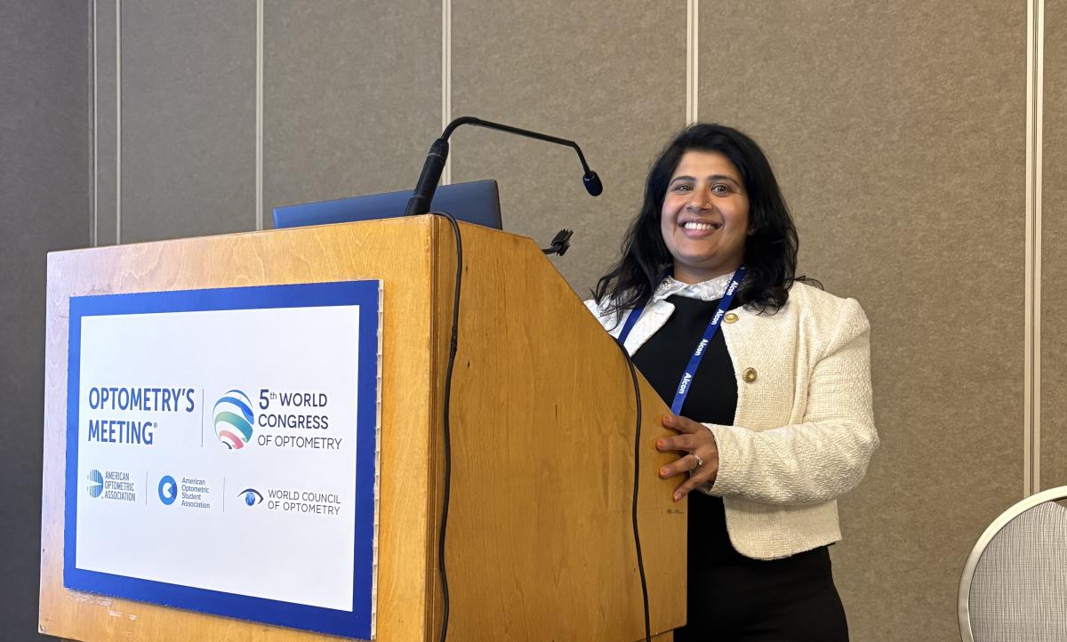 Sonal standing behind a lecturn