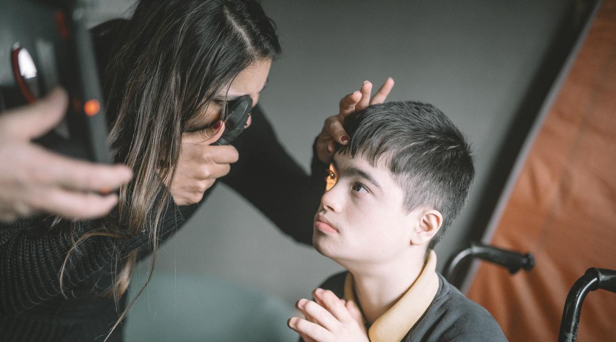 Yusuf has his eyes tested by an optometrist