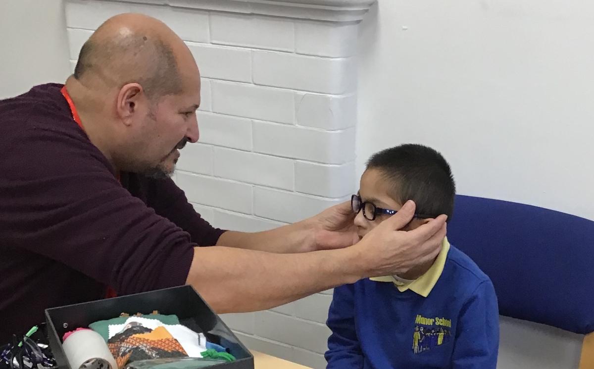 Mitch fits glasses on Zian