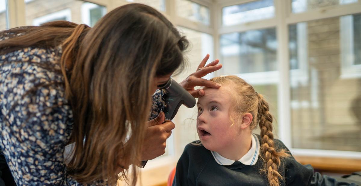 Malvi providing an eye check in a special school
