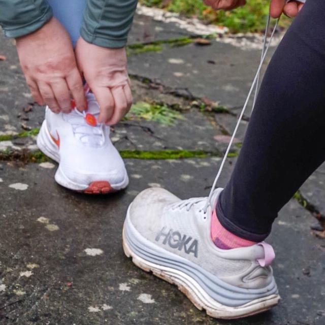 Grace and Shirley tie up their shoe laces.