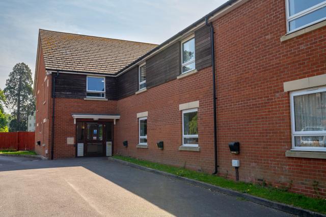 The outside of Henbury from the front, showing a large area to park cars.