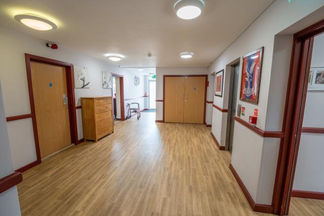A large hallway area at The Willows, flanked by doors providing access to communal areas.