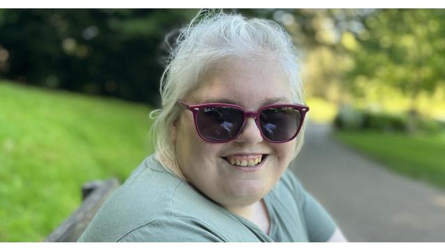 Lucy smiling in a park