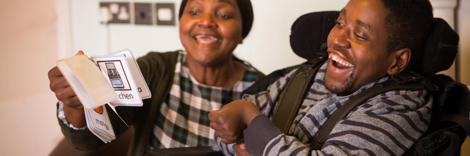 Norma showing Sadick some kay picture cards