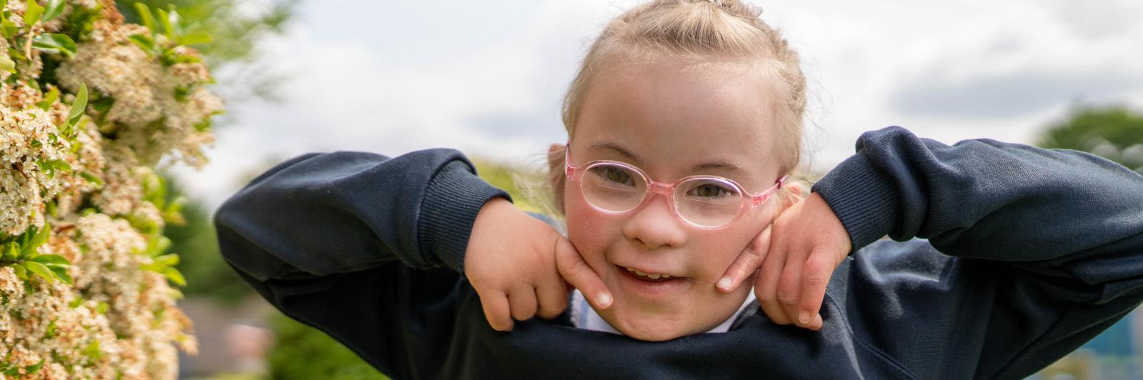 Ellie smile in a field with glasses