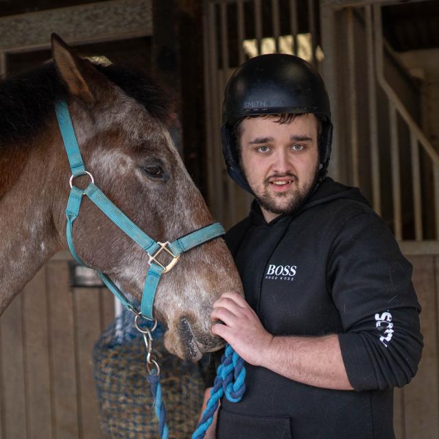 Charlie taking care of a horse