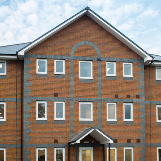 The outside of Buckinghamshire Support Service - a vibrant, modern brick home with three floors.