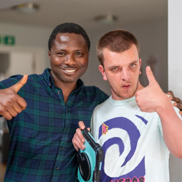 Jake and a support worker giving a thumbs up