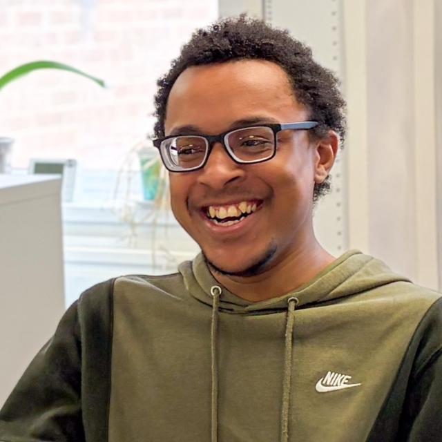 Terence smiles as he wears his new glasses