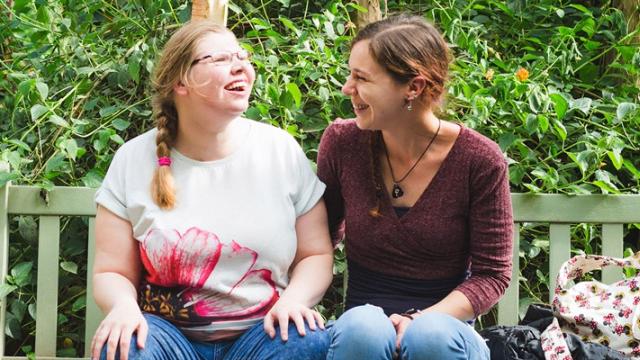 Two people sitting on a bench