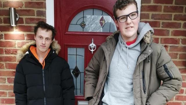 Two people standing in front of a door