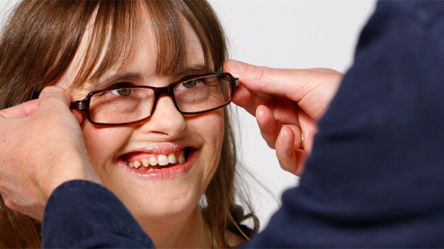 A girl trying on new glasses