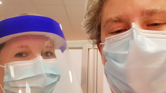 Two people wearing masks