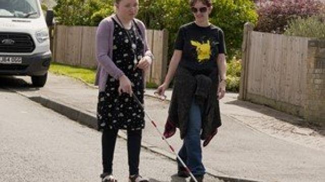 A person with sight loss walking