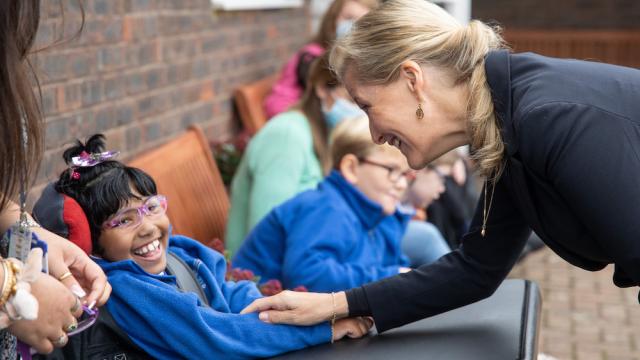 The Countess of Wessex greets a child at Perseid School
