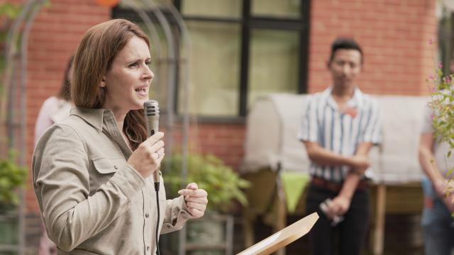 Lisa speaking to a group outdoors