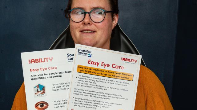 Emily holding up two of our eye care resources