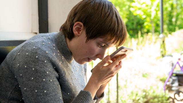 Summer who is blind, listening to voiceover on her phone