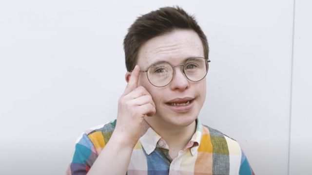 George Webster pointing to his glasses