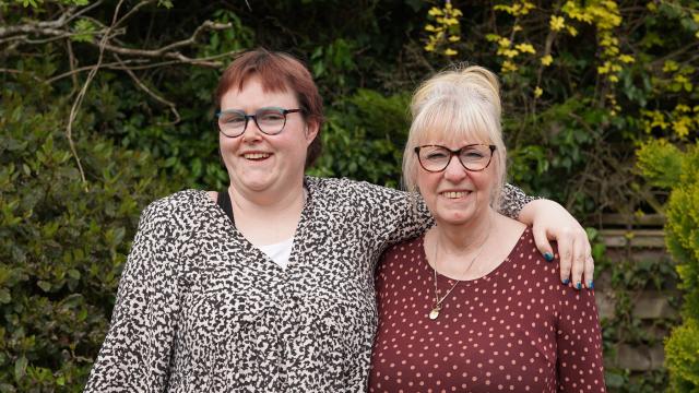 Grace and her support worker smiling