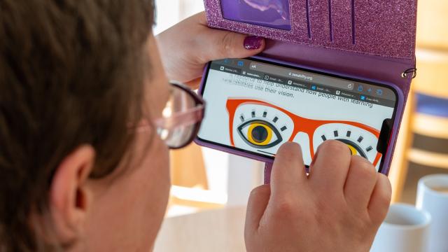 Grace reading one of our resources on her mobile phone